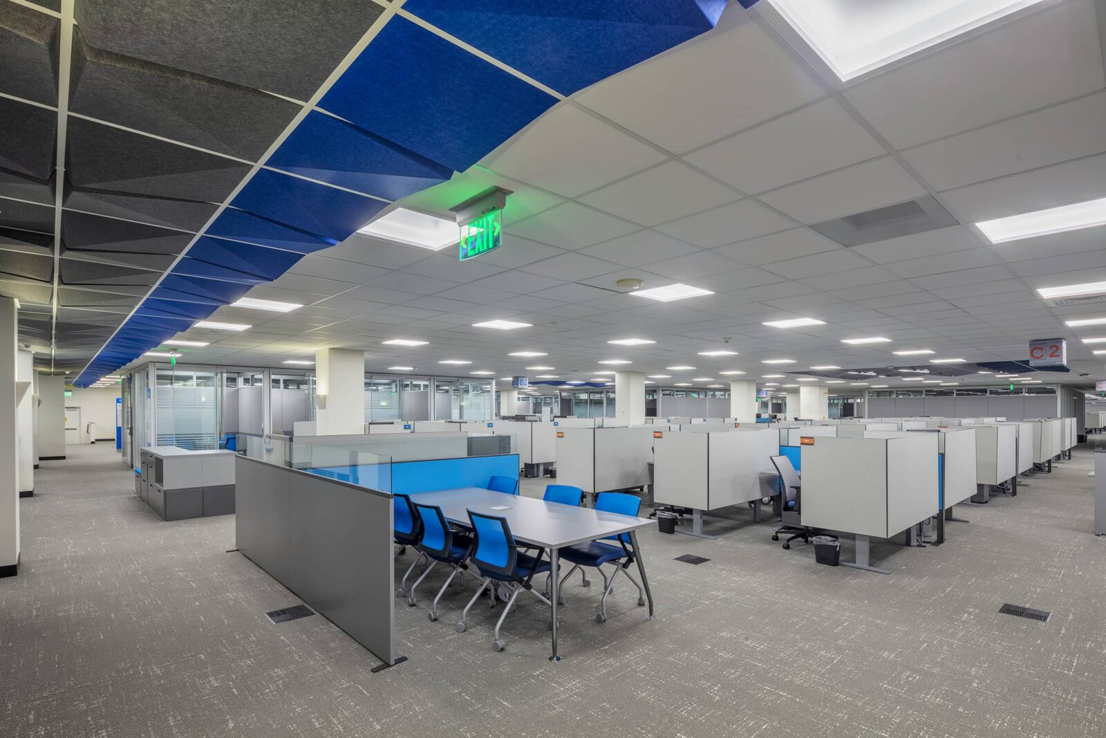Corporate office open workspace with partitioned workstations and meeting spaces