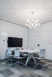 Meeting room with whiteboard walls, multimedia table and task chairs